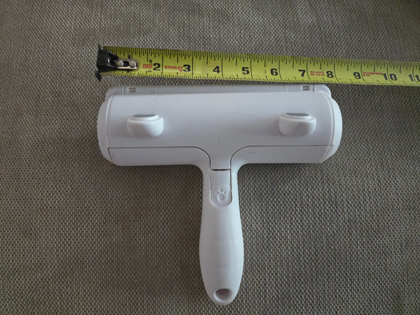 TidyTuft Roller measured against a tape measure, showing the 8.5 inch wide head