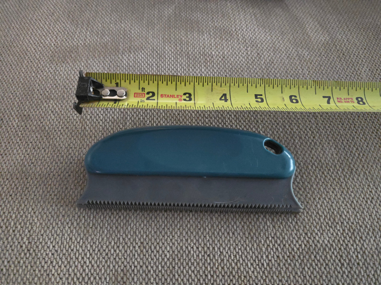 TidyTuft Carpet and Car Pet Hair Detailer beside a tape measure, showing the 6 inch serrated edge