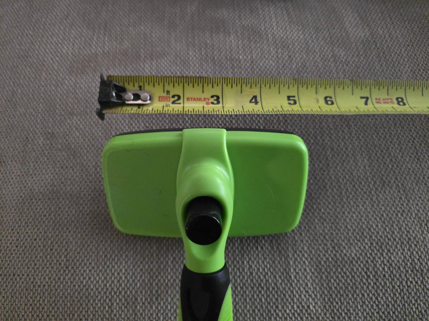 TidyTuft Self-Cleaning Slicker Brush head measured against a tape measure, about 5 inches wide
